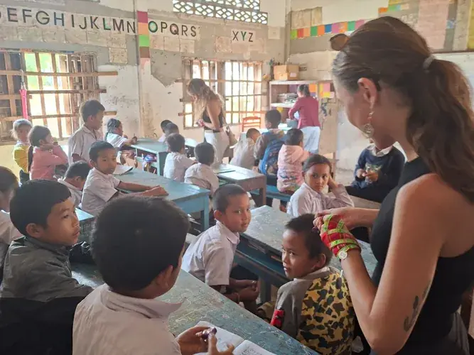 Visitors with Khmu children at village school, Vang Vieng