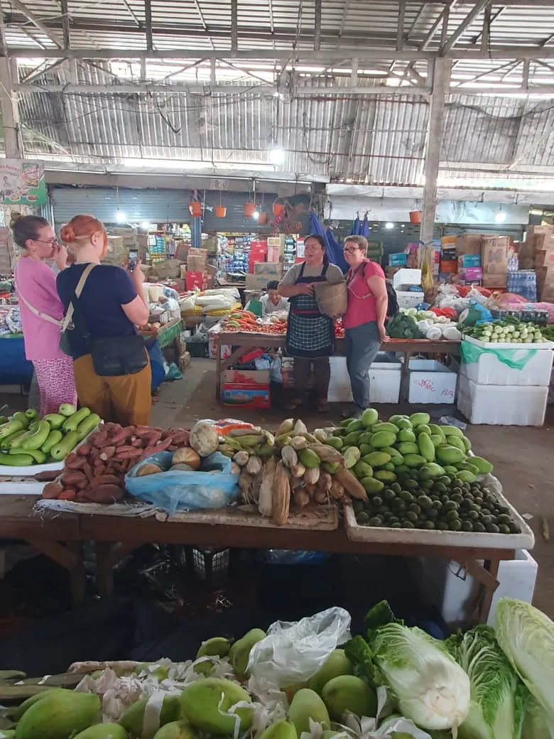 Guests with a local guide at the Vang Vieng morning market