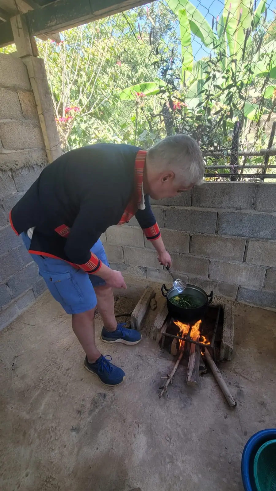Cooking class over a wood fire in traditional Khmu jacket